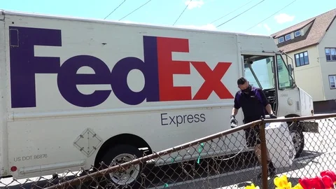 FedEx mail truck driver wears corona virus protective mask Stock Footage