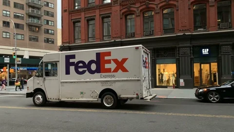 FedEx truck driving down Astor Place street Broadway Manhattan New York City NYC Stock Footage
