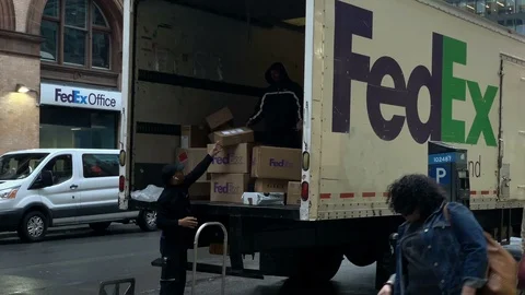 FedEx workers loading boxing in back of delivery truck from dolly Manhattan NYC Stock Footage 106973280