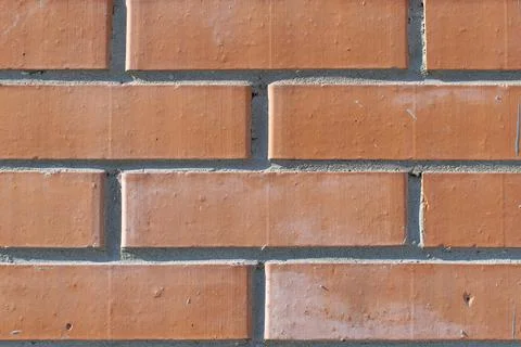 Feed, background, backdrop of red, orange clean new brick building wall Stock Photos