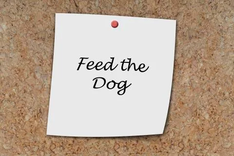 Feed the dog written on a memo Stock Photos