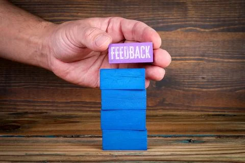 Feedback Concept with Hand Placing Block on Stack Representing Continuous I.. Stock Photos