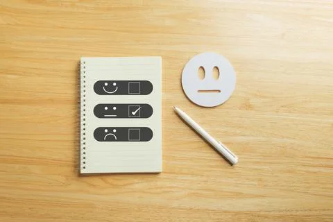 Feedback form for customer satisfaction survey showing neutral choice, pen .. Stock Photos