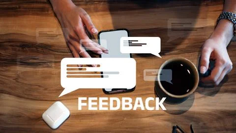 Feedback on a mobile phone while enjoying coffee at a wooden table in a relaxed Stock Photos