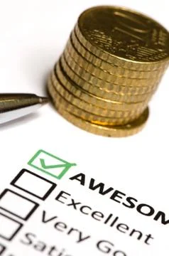 Feedback questionnaire and stack of coins and pen. Stock Photos