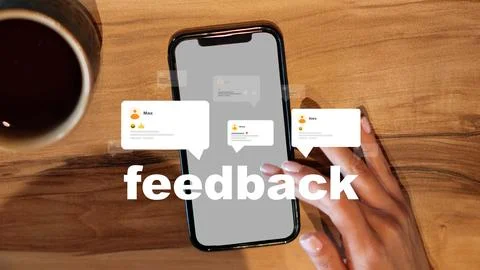 Feedback on a smartphone displayed on a wooden table with a coffee cup nearby Stock Photos