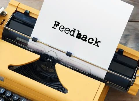 Feedback typed on yellow vintage typewriter - rating evaluation customer review Stock Photos