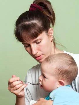 Feeding child Stock Photos