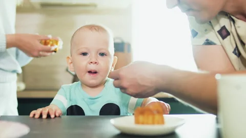 Feeding a funny one-year-old baby infant. Baby show tongue Stock Footage 241783574
