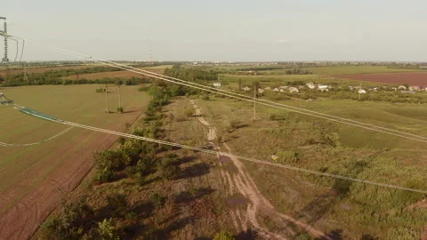 Feeding high voltage power through a power line into the countryside. Stock Footage 160121524