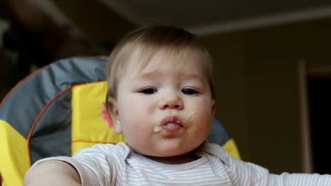 Feeding a little handsome baby boy porridge from a spoon, close-up. Nutrition Stockbeeldmateriaal 129959953