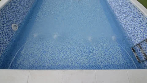 Feeding water into a swimming pool Stock Footage 105109637