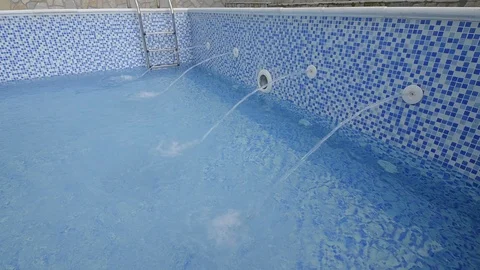 Feeding water into a swimming pool Stock Footage 105109929