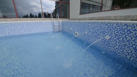 Feeding water into a swimming pool Stock Footage 105109943