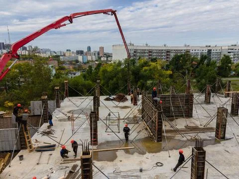Feeding the working mixture of concrete to the construction site with a concrete Stock Photos