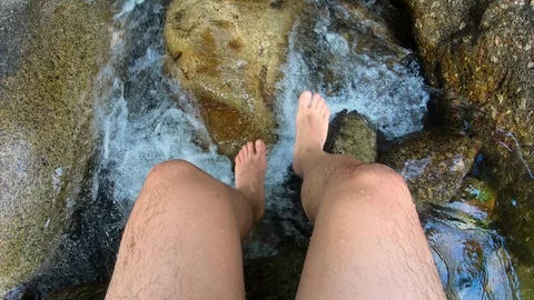 Feel so relax soaking leg in the river on summer vacation Stock Footage 125920588