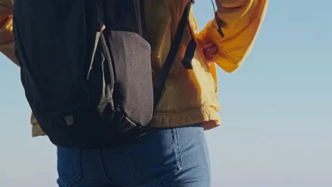 Feeling cold. Close-up of a woman with her hands in her jacket pocket Видео 169838992