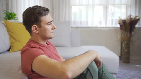 Feeling depressed at home, he put his hands on his head and got angry badly.  Stock-Footage 218910955