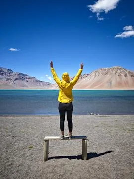 Feeling free: Young explorer standing in front of an alpine lake during a t.. Stock Photos