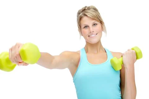 Feeling good about getting into shape. Sporty young woman lifting dumbbells Stock Photos