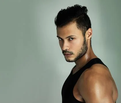 Feeling intimidated yet. Studio portrait of an athletic young man posing against Stock Photos