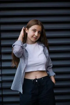 Feeling of joy. Young student with some folders poses on university campus Stock Photos