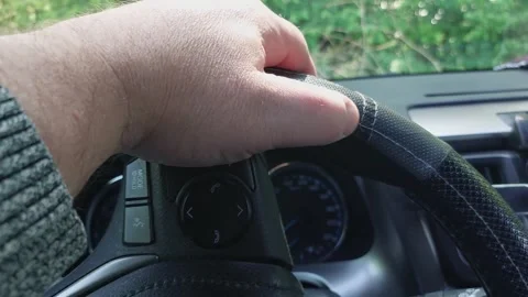 Feeling the leather cover on the steering wheel of a car with your fingers... Stock Footage 310999847