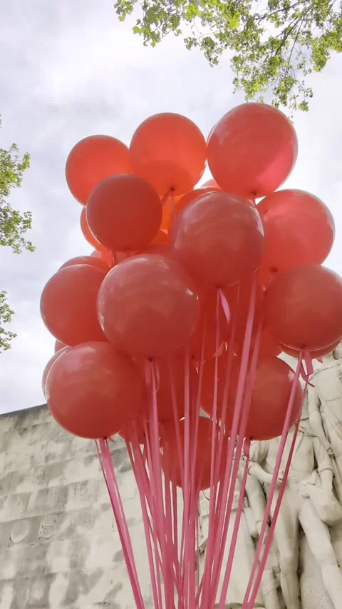 A feeling of lightness and joy. Bright red balloons swaying in a gentle breeze. Stock Footage 303970051