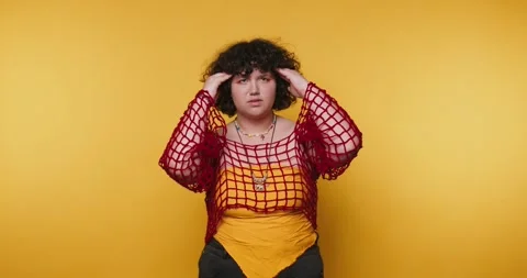 Feeling overwhelmed in a vibrant yellow setting during a candid moment of f.. Stock Footage 313273746