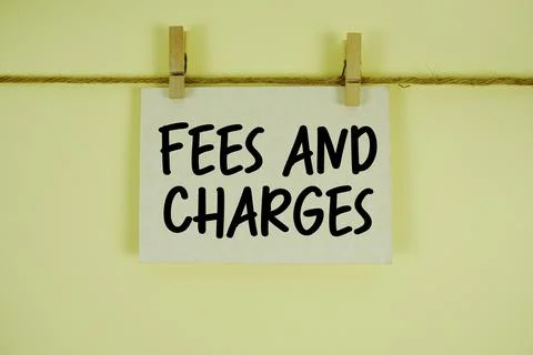 Fees And Charges paper notes hanging on the rope with clothespins Stock Photos