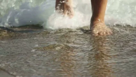 Feet are walking in the surf Stock Footage 81662074