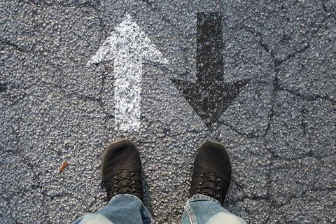 Feet on Asphalt with Forward and Backward Arrows Decision and Direction Concept Stock Photos