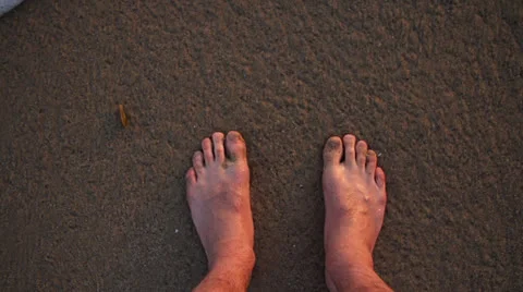 Feet On Beach Being Splashed by Water 240fps Stock Footage 23165663