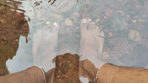 Feet being cleaned by fish in the pond Stock Footage 293243483