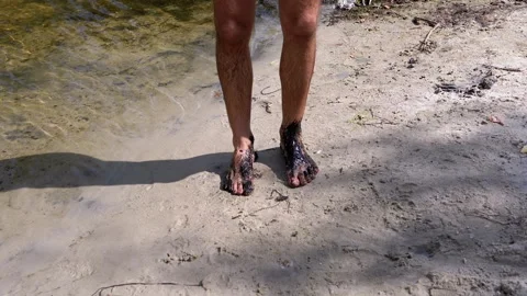 Feet in Black Mud by River Stock Footage 293263340
