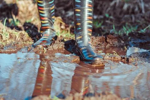 Feet in boots in mud Stock Photos