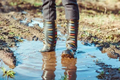 Feet in boots in mud Stock Photos