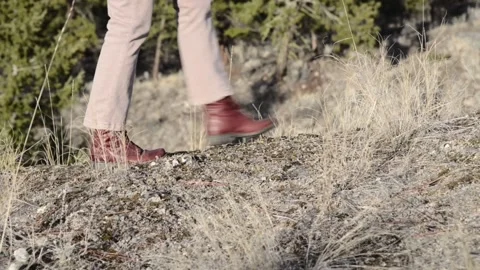 Feet, boots, walking left to right on rocky ground, woman Stock Footage 152097717