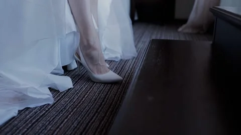 Feet of the bride in shoes and a wedding dress Stock Footage