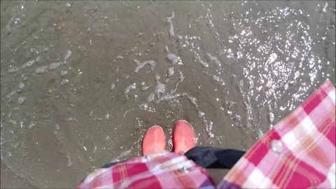 Feet Caressed By The Sea Waves Stock Footage 129095711