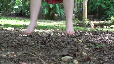 Feet of a child having fun on a rope swing in the middle of nature Stock Footage 274689314