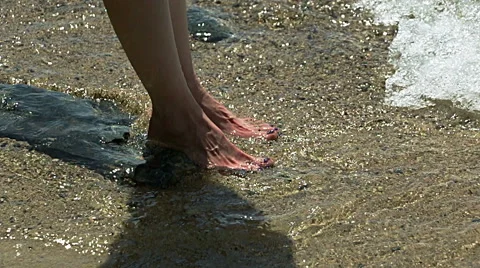 Feet close-up in the water at the beach Stock Footage 64433656