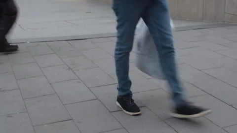 Feet commuters and men in work boots walking past city sidewalk Video stock 246713312