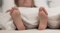 Feet of couple in comfortable bed, honeymoon sleeping time, romantic rest HD Footage
