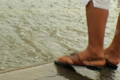 Feet curb rain Stock Footage 491990