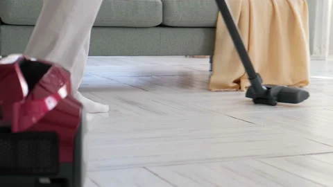 Feet of a dancing guy with a vacuum cleaner cleaning the room Stock Footage 127779692