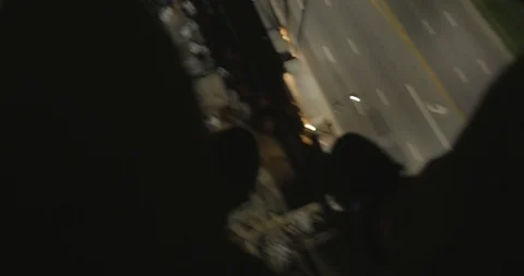 Feet Dangling Over Traffic at Night Stock Footage 87722326