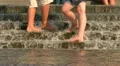 Feet of different people in water HD Footage