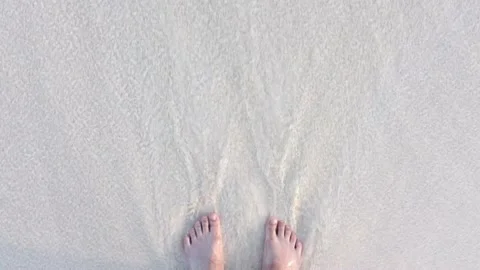 Feet feeling the and and waves on a beach in Bermuda Stock Footage 164168057