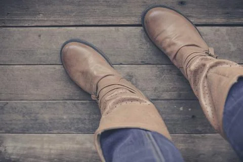 Feet. First-Person view  on rustic wood background. Stock Photos